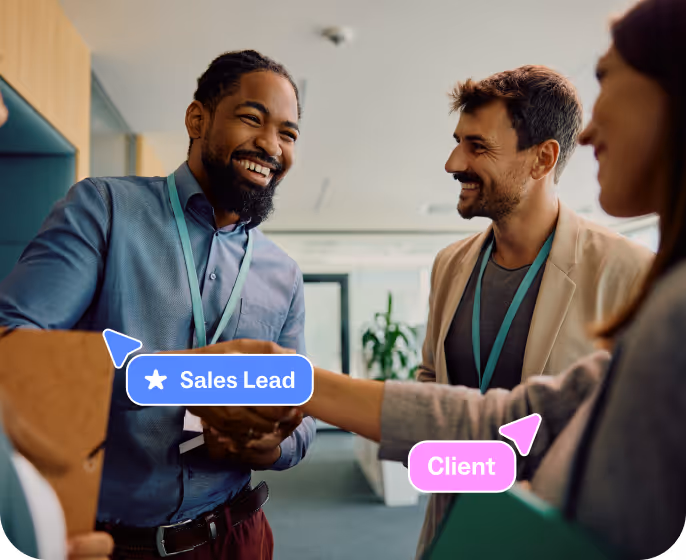 A Sales lead and client shaking hands in an office, illustrating a successful partnership.