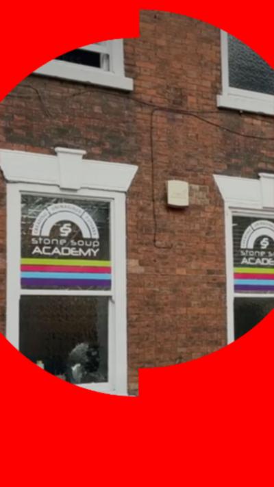 A photo of the windows of a school taken from the outside. 