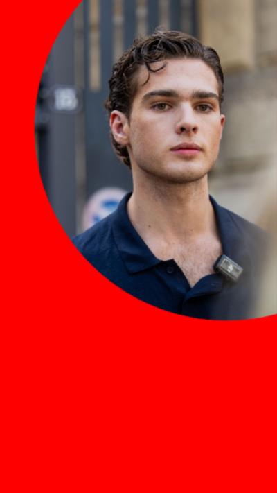 Streamer, Clavicular, wearing an open collared, navy shirt looking past the camera into the distance.