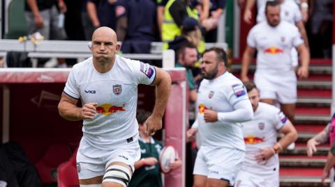 Captain Tom Christie leads out Newcastle Red Bulls in a white kit before their Prem Rugby Cup match at Leicester