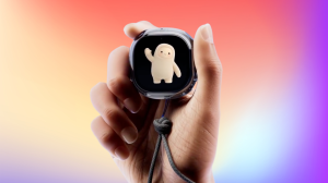 A hand holding the Muse Charm on a rainbow background